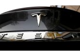 Tesla profits cut in half as demand falls